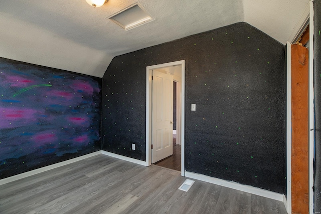 204 S Railroad St, Medora, IL 62063 - unfurnished bedroom with vaulted ceiling, wood finished floors, and baseboards