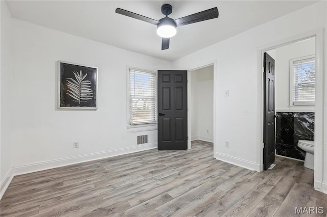 2808 Chadwick Dr, Bel-Nor, MO 63121 - unfurnished bedroom with light wood-type flooring, baseboards, and ceiling fan