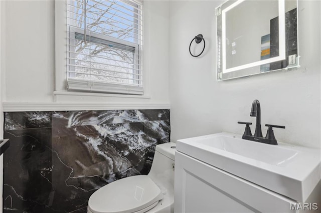 2808 Chadwick Dr, Bel-Nor, MO 63121 - half bath with toilet, vanity, and tasteful backsplash