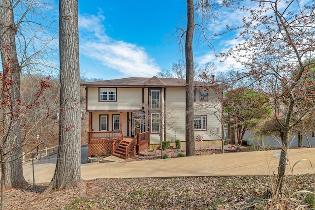 back of property featuring covered porch
