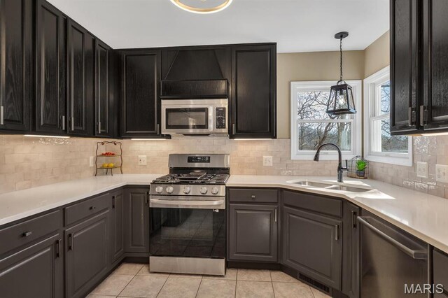 1972 Sugar Hollow Ct, Marthasville, MO 63357 - kitchen featuring stainless steel appliances, decorative backsplash, light countertops, and decorative light fixtures