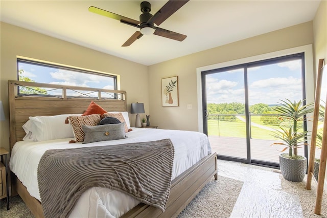 carpeted bedroom featuring access to exterior, multiple windows, and ceiling fan
