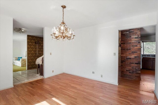 32 Briarcliffe Dr, Collinsville, IL 62234 - unfurnished dining area featuring wood finished floors and a chandelier