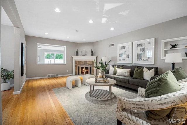 5816 Jamieson Ave, Saint Louis, MO 63109 - living area featuring light wood finished floors, baseboards, recessed lighting, and a fireplace