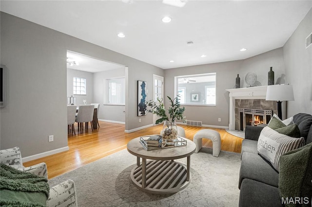 5816 Jamieson Ave, Saint Louis, MO 63109 - living area featuring light wood-style flooring, a tile fireplace, recessed lighting, and baseboards