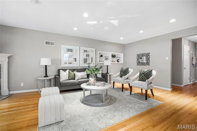 5816 Jamieson Ave, Saint Louis, MO 63109 - living room featuring light wood-type flooring, baseboards, recessed lighting, and a skylight