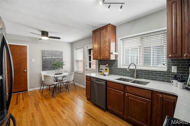 5816 Jamieson Ave, Saint Louis, MO 63109 - kitchen featuring a sink, appliances with stainless steel finishes, baseboards, light countertops, and tasteful backsplash