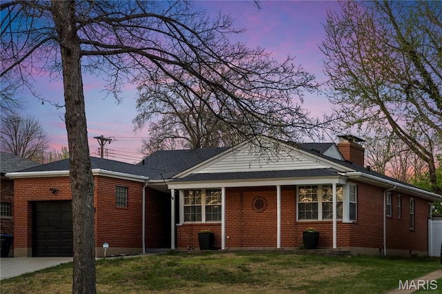 5816 Jamieson Ave, Saint Louis, MO 63109 - view of front of home featuring a garage, brick siding, a chimney, and a front yard