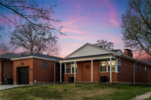 5816 Jamieson Ave, Saint Louis, MO 63109 - view of front of property with an attached garage, brick siding, a front lawn, driveway, and a chimney