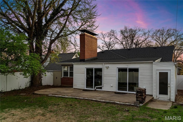 5816 Jamieson Ave, Saint Louis, MO 63109 - back of property at dusk with a patio area, a chimney, and a shingled roof
