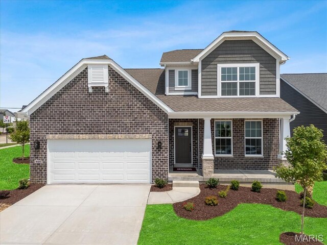 400 Thomlin Ct, Ofallon, MO 63367 - view of front of home with driveway, brick siding, a shingled roof, a porch, and an attached garage