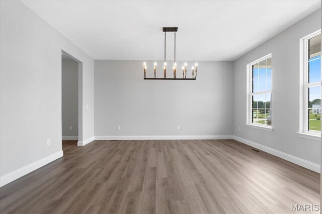 400 Thomlin Ct, Ofallon, MO 63367 - empty room featuring a chandelier and wood finished floors
