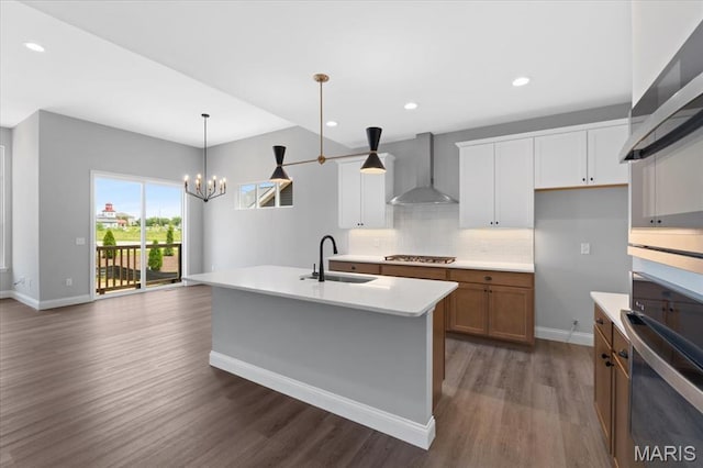400 Thomlin Ct, Ofallon, MO 63367 - kitchen featuring wall chimney range hood, stainless steel appliances, dark wood-style flooring, backsplash, and light countertops