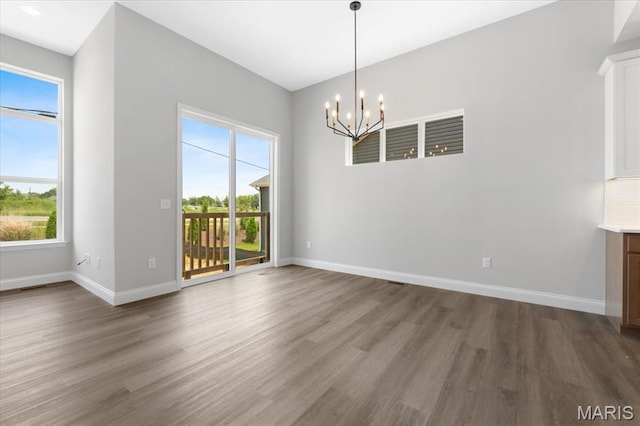 400 Thomlin Ct, Ofallon, MO 63367 - empty room with a chandelier, dark wood-style flooring, and plenty of natural light