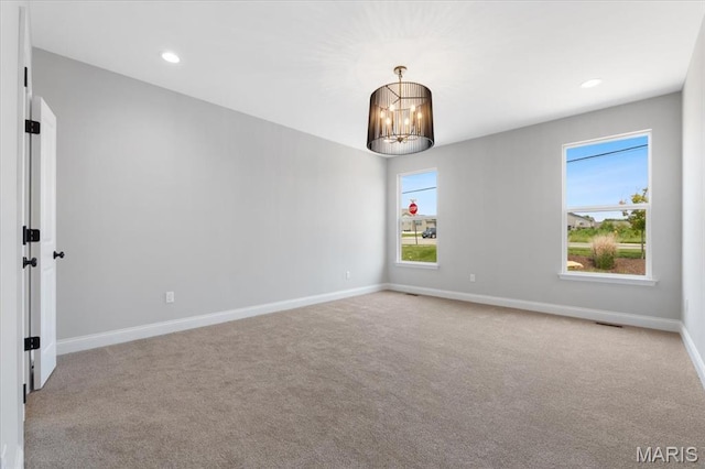 400 Thomlin Ct, Ofallon, MO 63367 - carpeted empty room with healthy amount of natural light, a chandelier, and recessed lighting