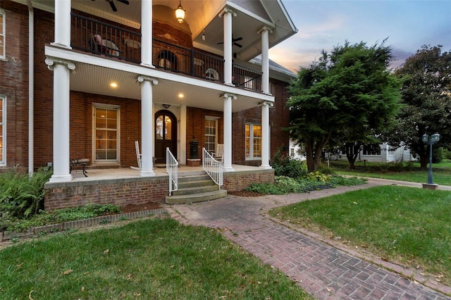 1011 N Ranney St, Sikeston, MO 63801 - property entrance featuring a balcony, brick siding, a porch, and a yard