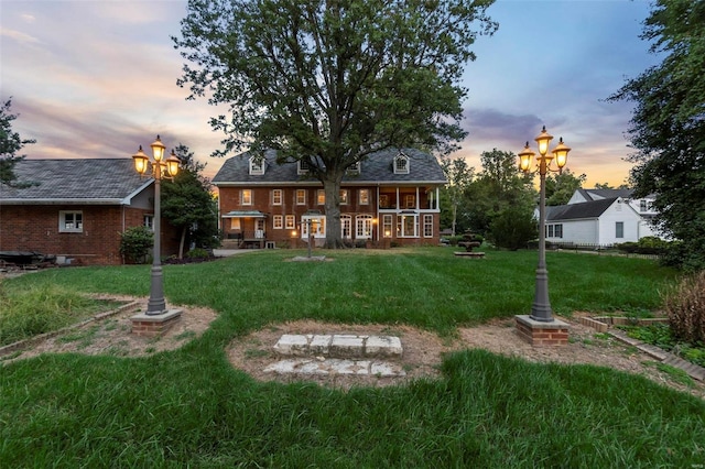 1011 N Ranney St, Sikeston, MO 63801 - back of house featuring a yard and brick siding