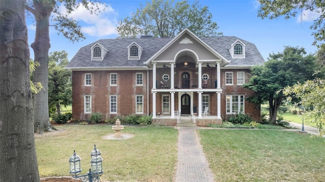 1011 N Ranney St, Sikeston, MO 63801 - greek revival inspired property featuring a balcony, a porch, a front yard, and brick siding