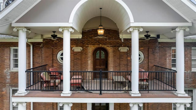 1011 N Ranney St, Sikeston, MO 63801 - view of exterior entry with brick siding, ceiling fan, and a balcony