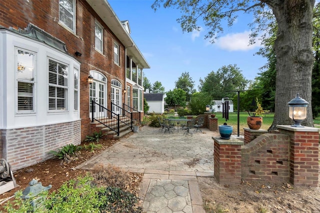 1011 N Ranney St, Sikeston, MO 63801 - view of patio / terrace featuring entry steps, outdoor dining space, and french doors