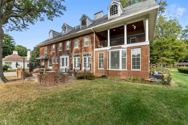 1011 N Ranney St, Sikeston, MO 63801 - rear view of property with brick siding, a balcony, a lawn, and french doors