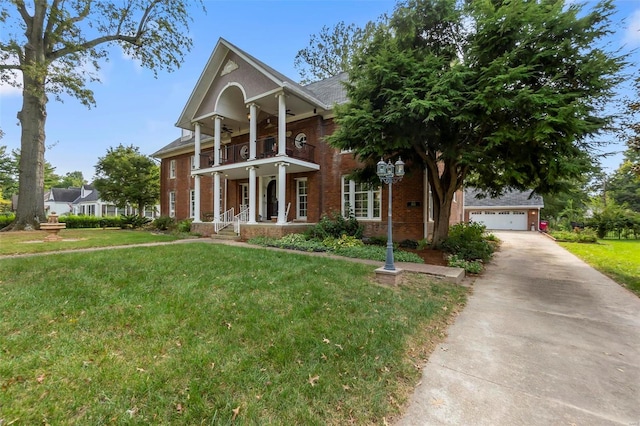 1011 N Ranney St, Sikeston, MO 63801 - greek revival inspired property featuring a balcony, brick siding, a ceiling fan, a front yard, and driveway