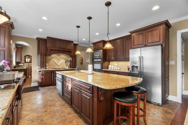 1011 N Ranney St, Sikeston, MO 63801 - kitchen with stainless steel appliances, ornamental molding, arched walkways, decorative backsplash, and recessed lighting