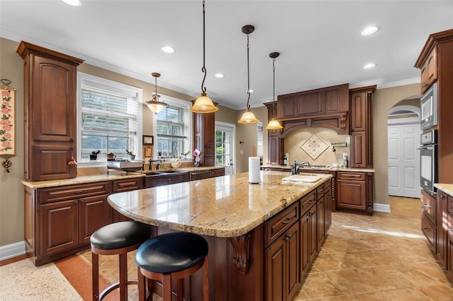 1011 N Ranney St, Sikeston, MO 63801 - kitchen featuring wall oven, a center island with sink, recessed lighting, a sink, and ornamental molding