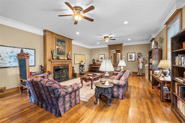 1011 N Ranney St, Sikeston, MO 63801 - living area featuring a ceiling fan, a premium fireplace, recessed lighting, wood finished floors, and ornamental molding