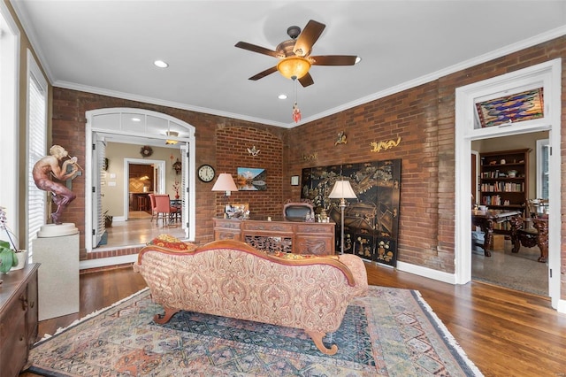 1011 N Ranney St, Sikeston, MO 63801 - living room featuring brick wall, ceiling fan, wood finished floors, arched walkways, and recessed lighting