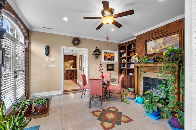 1011 N Ranney St, Sikeston, MO 63801 - dining area with baseboards, a glass covered fireplace, a ceiling fan, ornamental molding, and speckle patterned floor