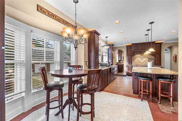 1011 N Ranney St, Sikeston, MO 63801 - dining area with arched walkways, ornamental molding, a chandelier, recessed lighting, and baseboards
