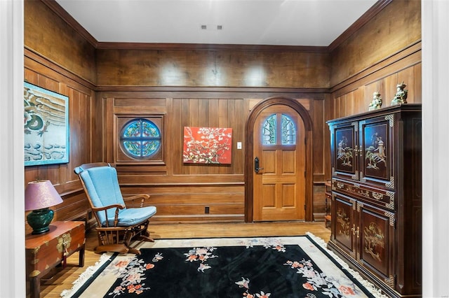 1011 N Ranney St, Sikeston, MO 63801 - foyer entrance with light wood-style floors, ornamental molding, and wood walls