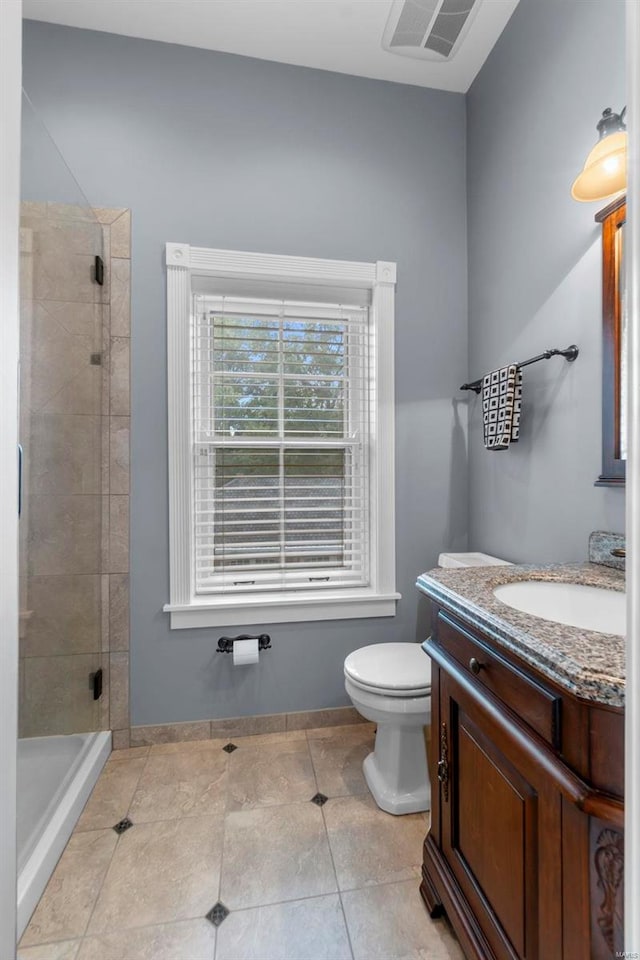 1011 N Ranney St, Sikeston, MO 63801 - full bathroom featuring a shower stall, toilet, vanity, tile patterned floors, and baseboards