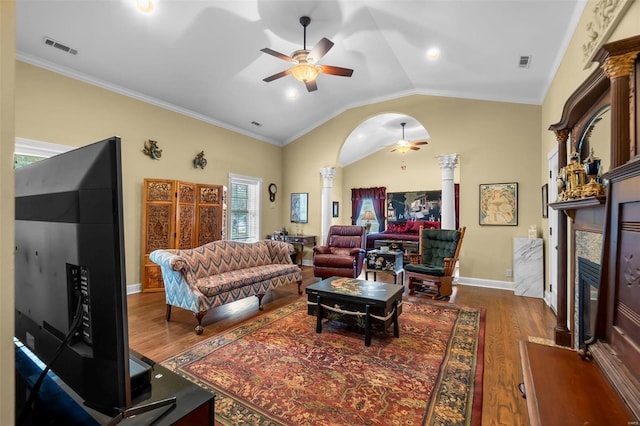 1011 N Ranney St, Sikeston, MO 63801 - living room with decorative columns, a ceiling fan, wood finished floors, lofted ceiling, and a glass covered fireplace