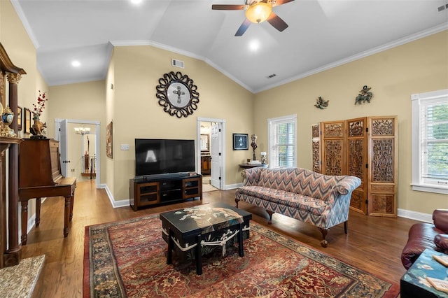 1011 N Ranney St, Sikeston, MO 63801 - living area featuring vaulted ceiling, a ceiling fan, wood finished floors, crown molding, and baseboards