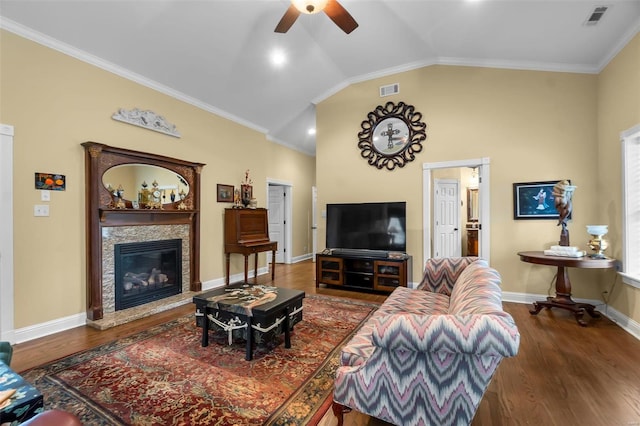 1011 N Ranney St, Sikeston, MO 63801 - living room featuring a ceiling fan, vaulted ceiling, wood finished floors, a glass covered fireplace, and ornamental molding