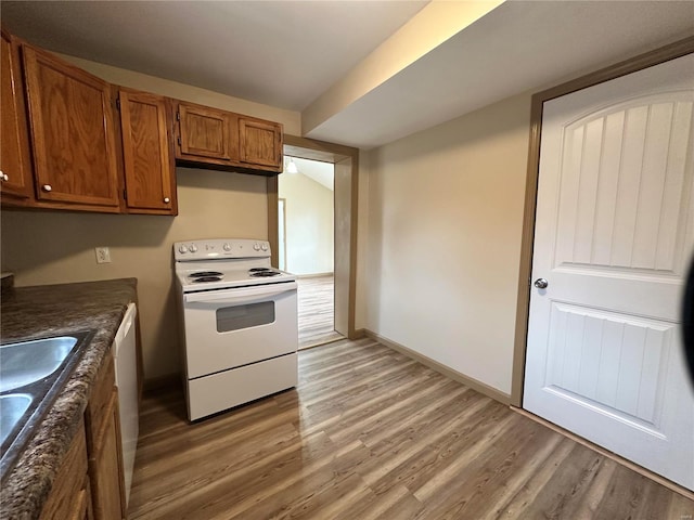 117 Pine St, Sullivan, MO 63080 - kitchen with electric range, brown cabinets, light wood-type flooring, and dark countertops