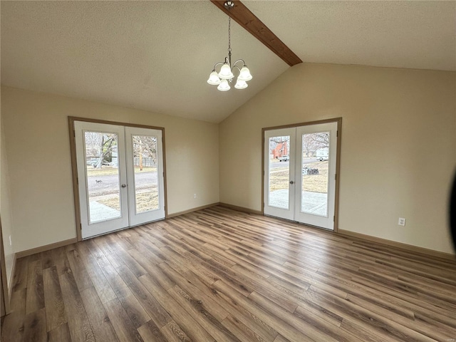 117 Pine St, Sullivan, MO 63080 - unfurnished dining area featuring french doors, plenty of natural light, wood finished floors, a chandelier, and a textured ceiling