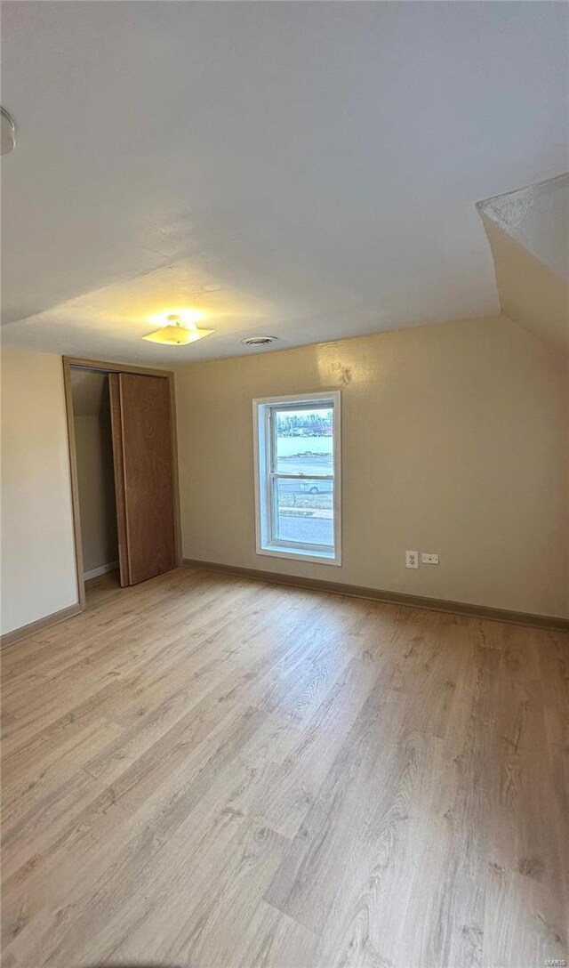 117 Pine St, Sullivan, MO 63080 - unfurnished bedroom featuring light wood-type flooring, a closet, baseboards, and vaulted ceiling