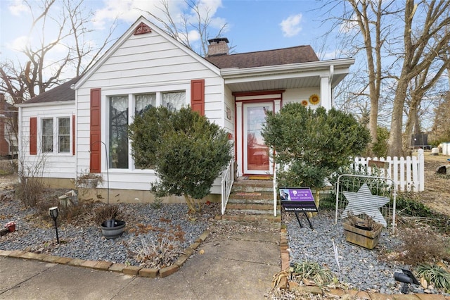 524 N St, Farmington, MO 63640 - view of front of home with a chimney, a shingled roof, and fence