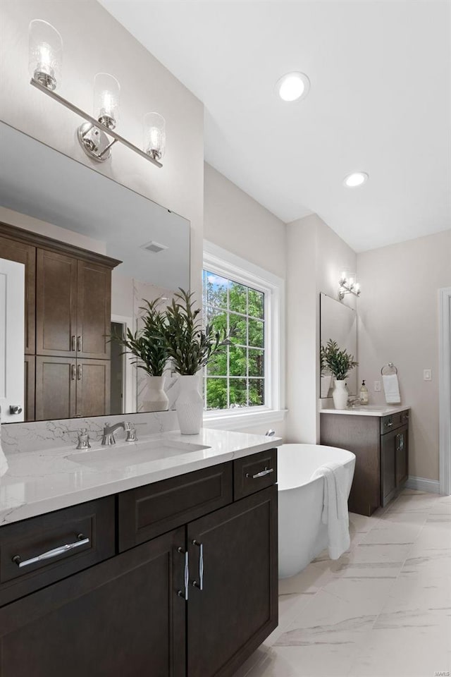 8 Briarbrook Trl, Saint Louis, MO 63131 - full bath with marble finish flooring, a freestanding tub, vanity, and recessed lighting