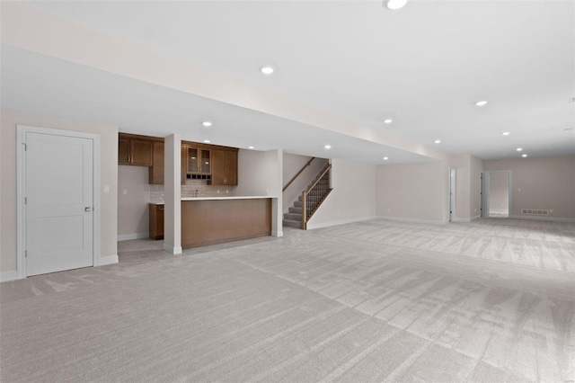 8 Briarbrook Trl, Saint Louis, MO 63131 - unfurnished living room with light carpet, baseboards, recessed lighting, and stairway