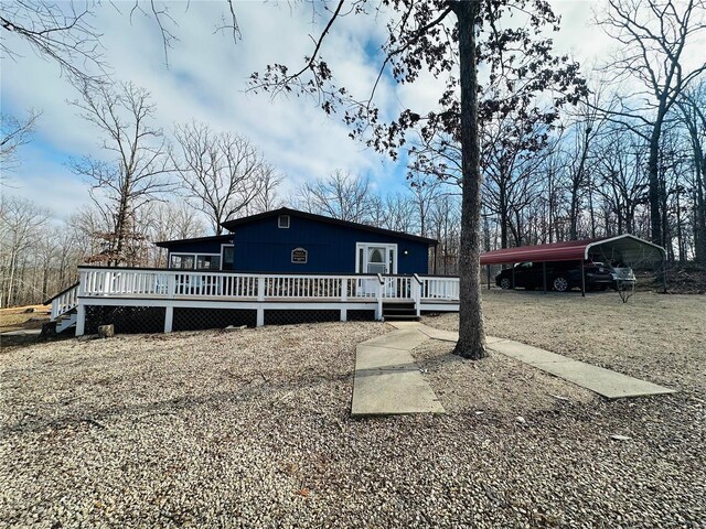 view of front facade with a carport and a deck