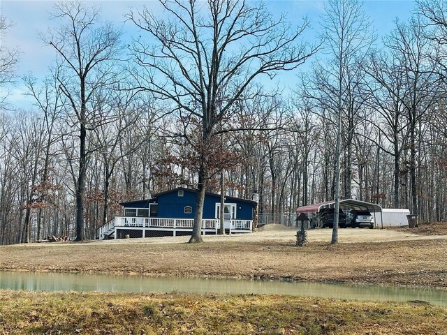 view of yard featuring a carport and a deck