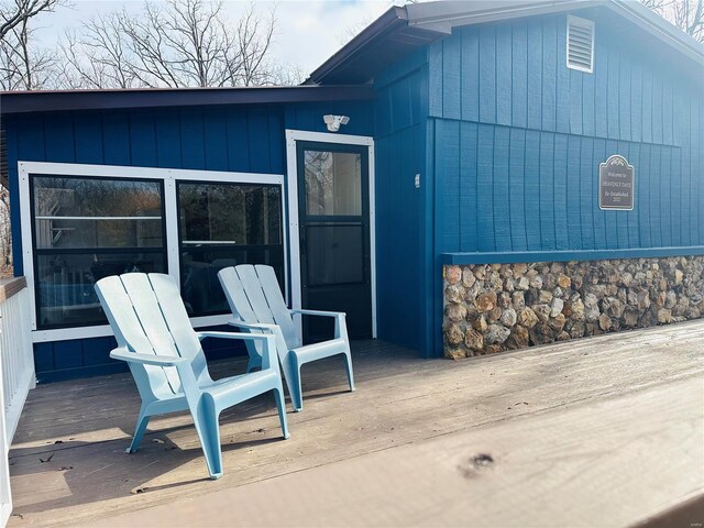 view of exterior entry with a wooden deck