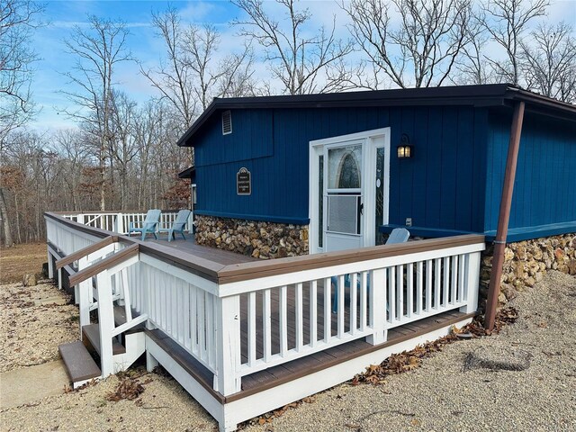 rear view of house featuring a wooden deck