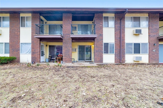 7579 Hazelcrest Dr Unit A, Hazelwood, MO 63042 - rear view of house with a balcony and brick siding