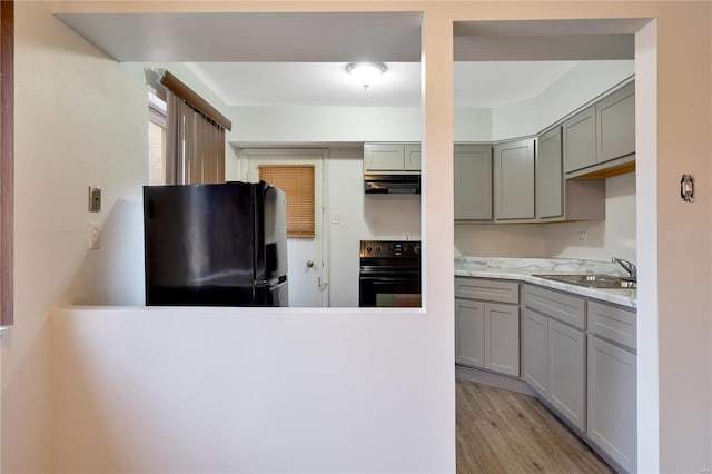 7579 Hazelcrest Dr Unit A, Hazelwood, MO 63042 - kitchen featuring black appliances, gray cabinetry, a sink, and under cabinet range hood
