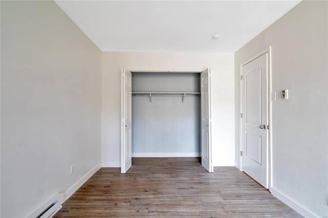 7579 Hazelcrest Dr Unit A, Hazelwood, MO 63042 - unfurnished bedroom with a closet, wood finished floors, baseboards, and baseboard heating